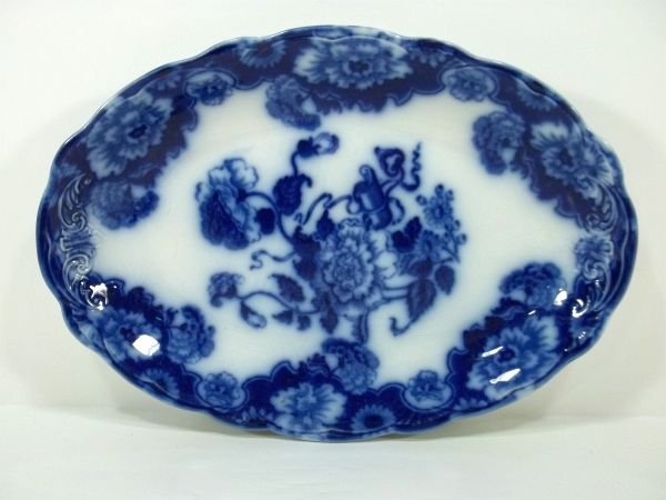 Flow Blue Staffordshire Platter: New Wharf Pottery England "Chrysanthemum". c1890. One small back side rim flake. Measures approx. 12.5" long. Please Note: This one owner Flow Blue collection is generally in very good condition. Howe
