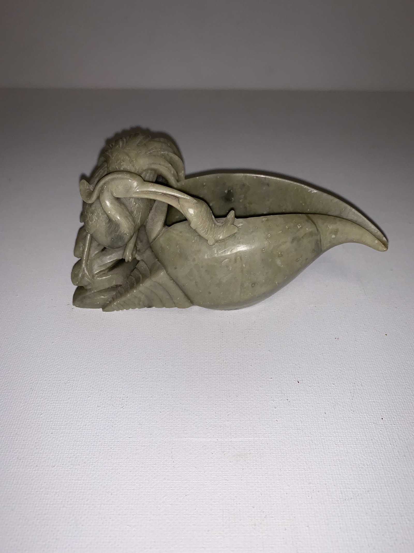 Soapstone Shell: A Soapstone carved Shell with a fine carved bird eating a fish 2.75"h 6.5"w