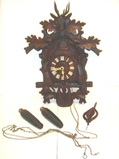 American Black Forest Coo Coo Clock : Outstanding Amrican coocoo clock in the black forest style, with carved wildlife throughout. Condition is goos with small repairs to cracks as shown in photo. Approx 17" x 10".