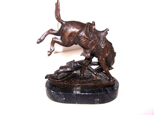 Frederic Remington Bronze Recast: Small 9' tall bronze recast of Frederic Remington of bucking wild horse and down rider.Wicked Pony