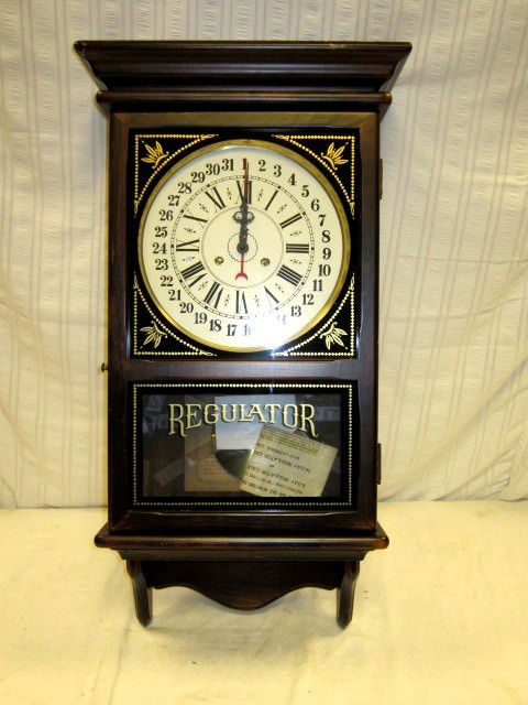 8 Day New England Regulator Wall Clock: very nice, working regulator with pendulum, key and paper work. Dated 1974, approx 30" x 14" in size.