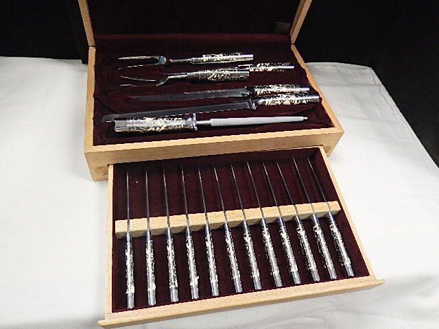 Knife Set of Carvel Hall by Briddel Cutlery: 18 pieces- 3 Carving knives, Sharpener, 2 Serving Forks , 12 Steak Knives, stainless steel,faux ivory and floral motif handle. In Original case marked with maker's name, Carvel Hall by Briddell