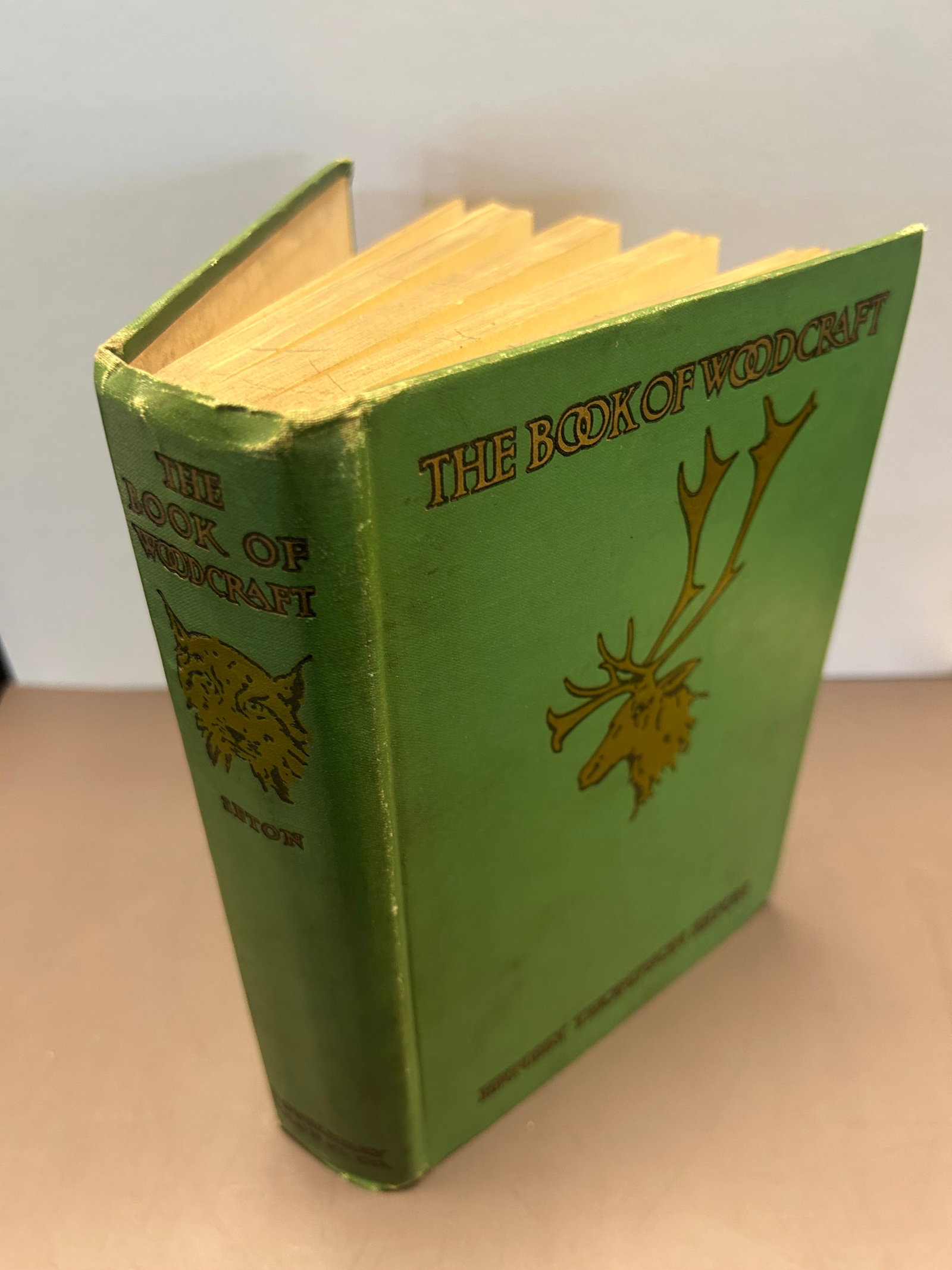 THE BOOK OF WOODCRAFT, ERNEST THOMPSON SETON, 1915: HARDCOVER EDITION OF THE BOOK OF WOODCRAFT BY ERNEST THOMPSON SETON, 1915, GREEN CLOTH BINDING AND GOLD ELK HEAD EMBLEM, OVERALL GOOD CONDITION