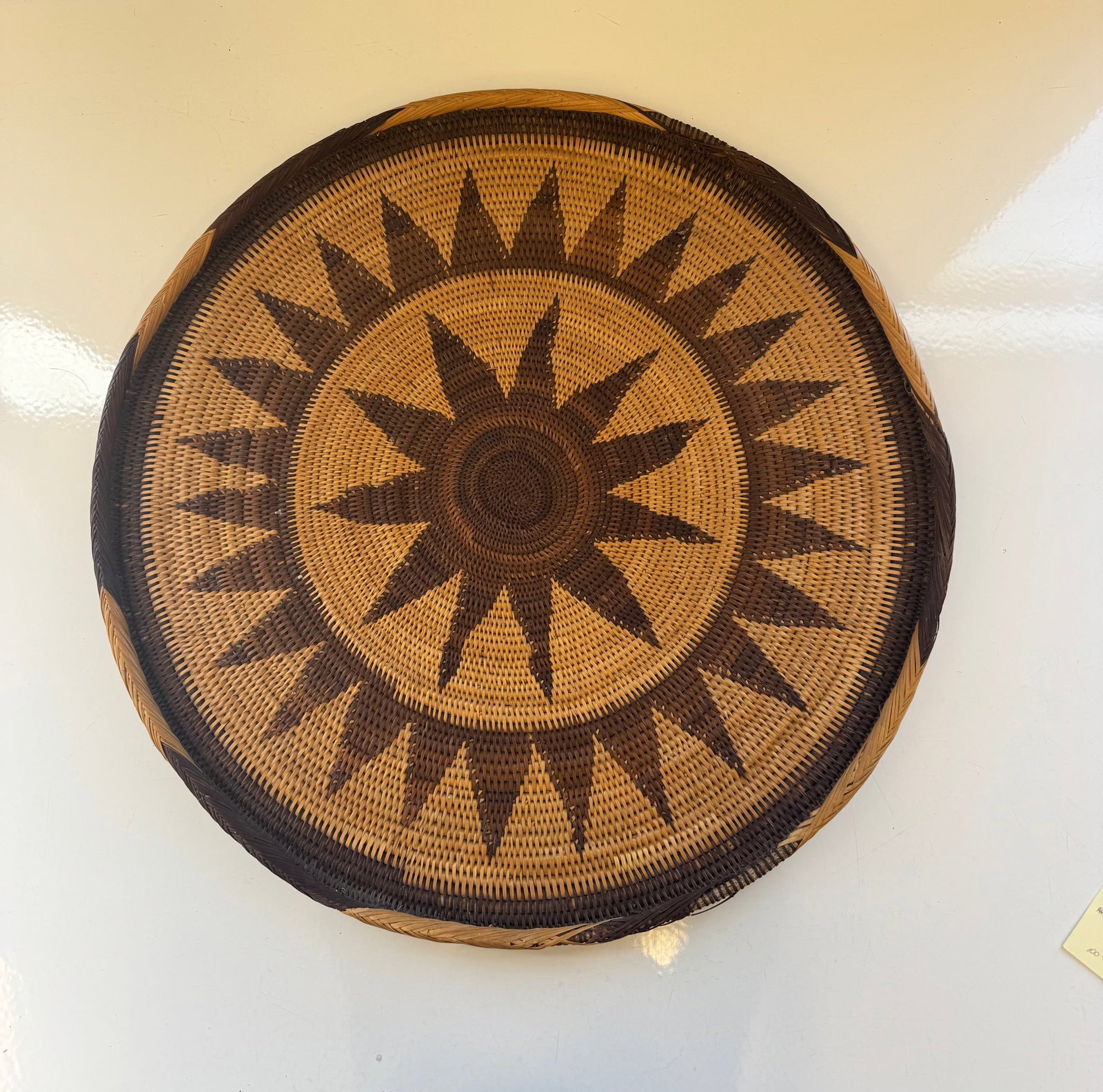 LARGE VINTAGE INDIAN WOVEN SUNBURST BASKET: STRIKING TWO TONE GEOMETRIC SUNBURST PATTERNEXCELLENT VINTAGE CONDITION WITH SOME MINOR WEAR.APPROX: 23" DIAMETERPROVENANCE: ESTATE OF DOUG DIVISH NORTH EAST OHIO