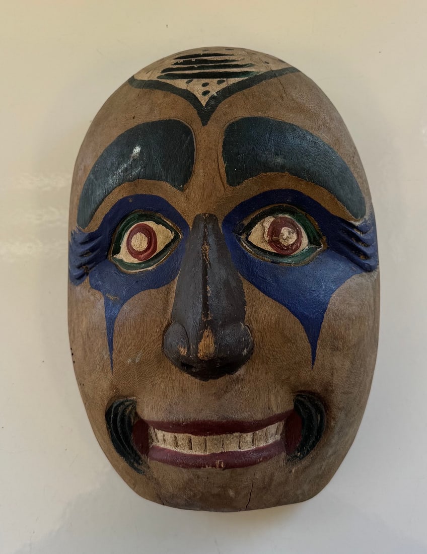 MID-20TH CENTURY KWAKIUTL SPEAKER/HUMANOID MASK: MEASURED FROM THE BACK APRROX 11.5' X 8" HAND CARVED FROM A SINGLE PIECE OF WOODGREAT ORIGINAL CONDITION WITH RICH NATURAL PATINA AND AGE APPROPRIATE SURFACE CRACKING.PROVENANCE: ESTATE OF DOUG DIVISH