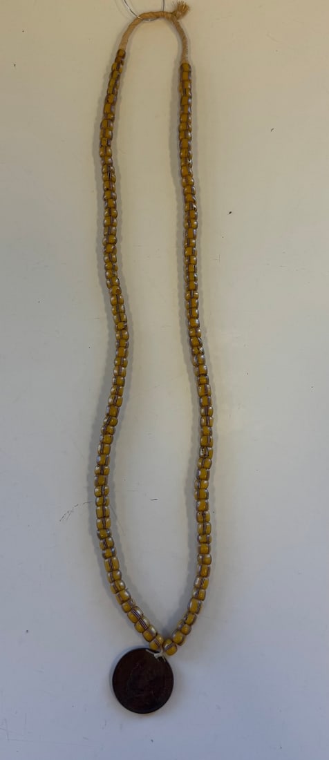 1881 JAMES A. GARFIELD MEDAL: 1881 JAMES A. GARFIELD BRONZE MEDAL, STRUNG ON YELLOW STRIPED GLAQSS BEADS.MOURNING/ MEMORIAL MEDAL.MEDAL IS 1" DIA.NECKLACE IS 12"PROVENANCE: ESTATE OF DOUG DIVISH NORTH EAST OHIO