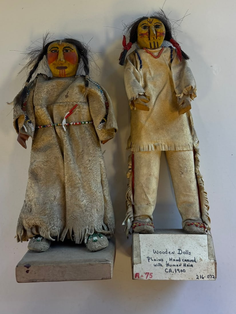 RARE SKOOKUM HAND CARVED PAIR OF DOLLS: RARE AND EXCEPTIONAL SKOOKUM WOODEN HAND CARVED WITH HUMAN HAIR, CIRCA 1900ATTACHED BUCKEYE INDIAN MUSEUM , ORRVILLE OHIOAPPROX 10" TO 10.5" NOT INCLUDING STANDSPROVENANCE: ESTATE OF DOUG DIVISH NORTH