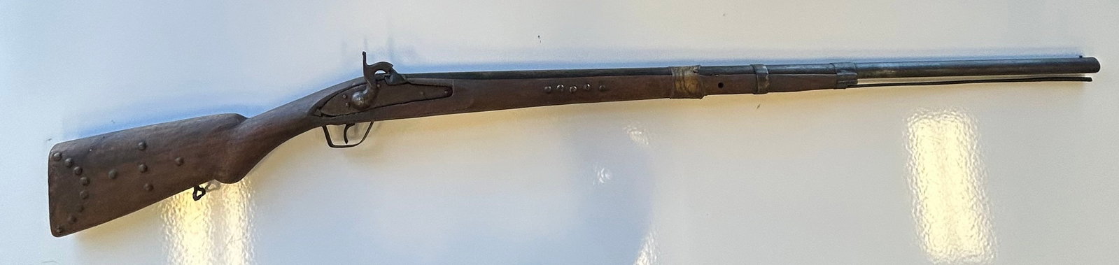 ANTIQUE RIFLE: MAKER-PARKER FIELD & CO. 1868 HAND STAMPED ON BARREL. GA/CAL 14GA/.60 CAL.CRUDE HOME MADE GUN, PIECED TOGETHER FROM RANDOM PARTS. RAWHIDE REPAIRS AND INDIAN TACKS.PROVENANCE: ESTATE OF DOUG DIVISH NOR