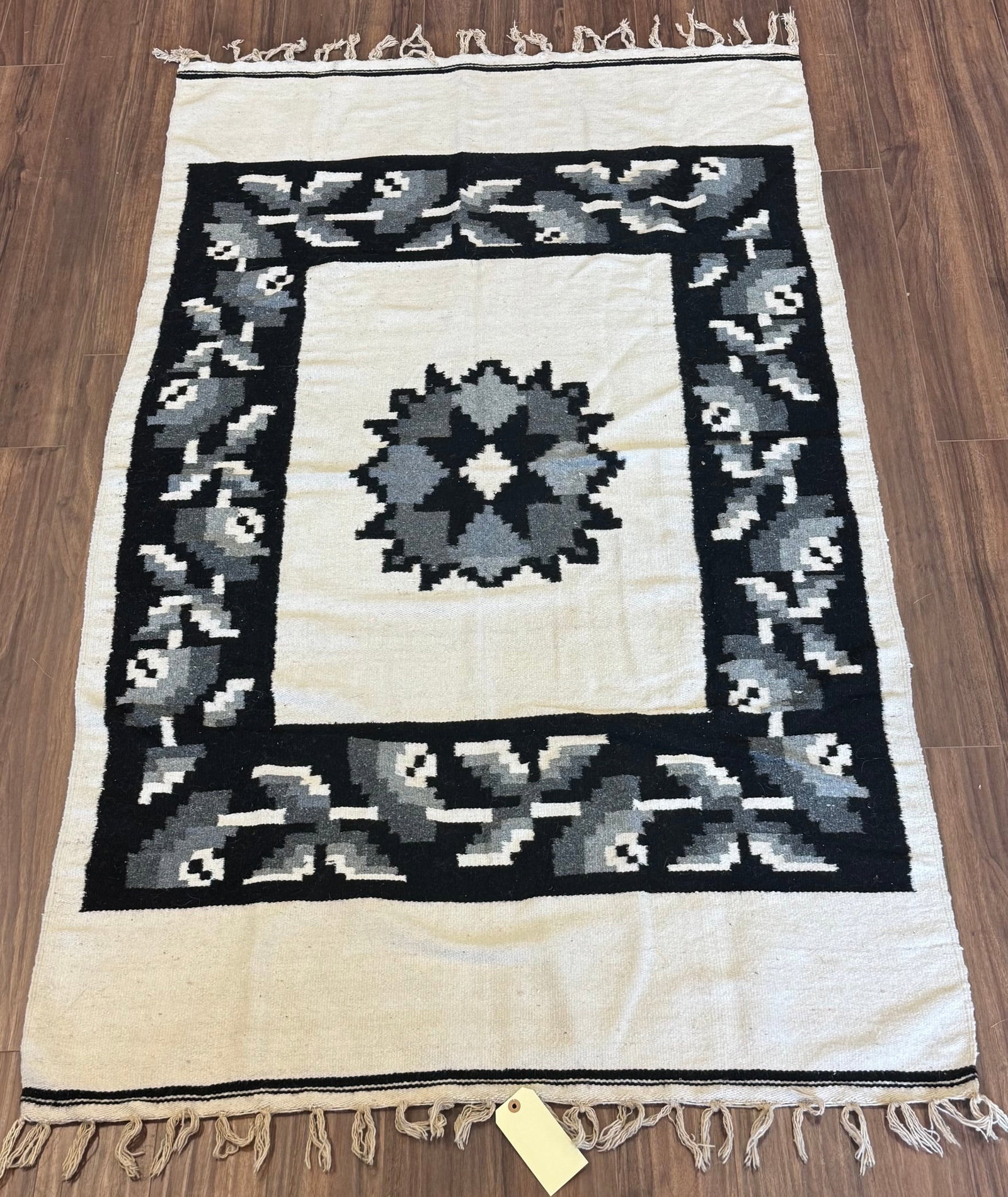 BEAUTIFUL VINTAGE HANDWOVEN WOOL SOUTHWEST THROW: BLACK, GRAY, AND CREAM GEOMETRIC THROW WITH KNOTTED FRINGEAPPROX: 82.5" X 48"PROVENANCE: ESTATE OF DOUG DIVISH NORTH EAST OHIO