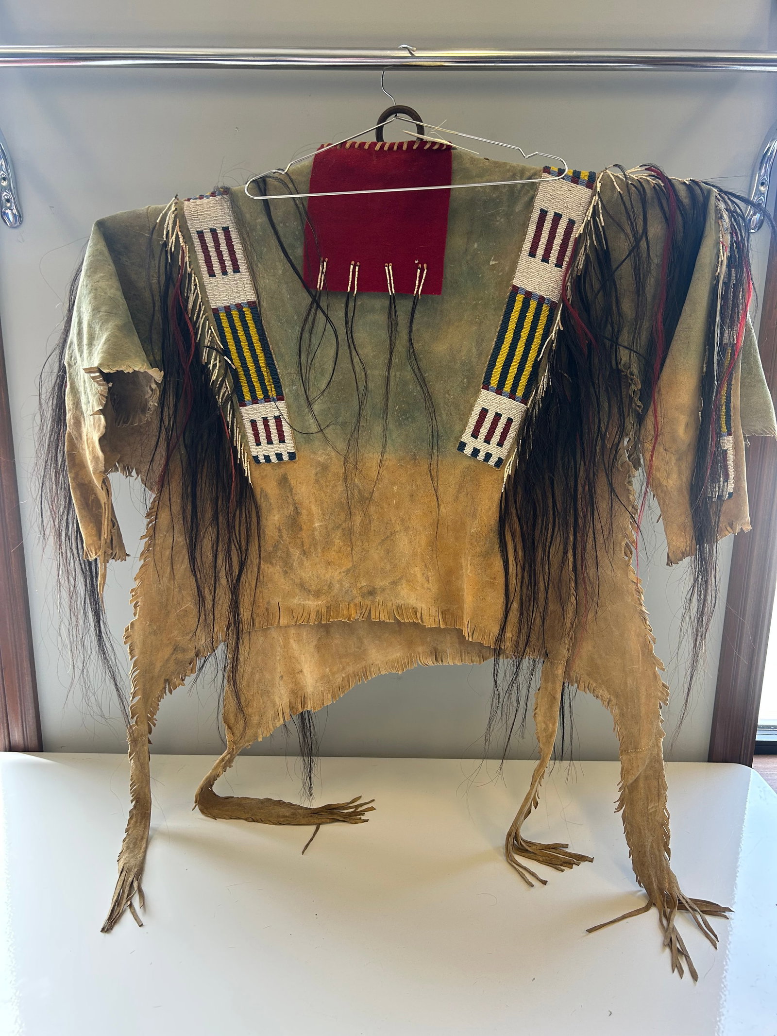 GALLERY QUALITY PLAINS STYLE BEADED HIDE WAR SHIRT: A BREATHTAKING, MUSEUM GRADE CONTEMPORY TRIBUTE TO HISTORIC 19TH CENTURY GARMENTS WORN BY DISTINGUISHED PLAINS TRIBAL LEADERS. METICULOUS BEADWORK, SOFT TANNED ANIMAL HIDE FEATURING A CLASSIC