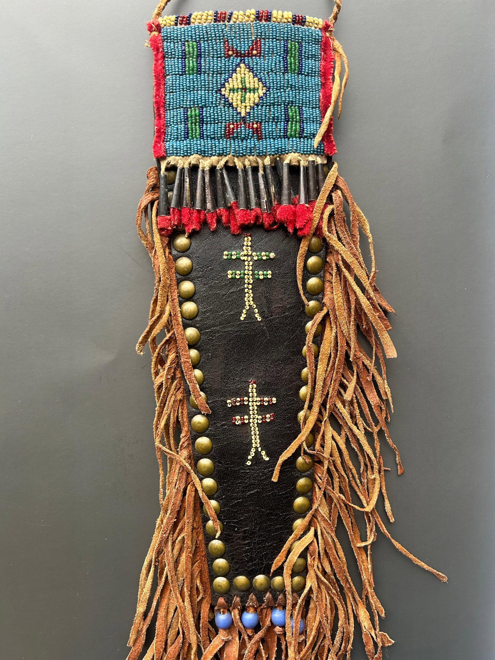 PLAINS STYLE BEADED HIDE KNIFE SCABBARD: GOOD CONDITION, BEADWORK TIGHT AND LARGELY INTACT APRROX 12", POSSIBLE REPLICA PROVENANCE: ESTATE OF DOUG DIVISH, NORTHEAST OHIO