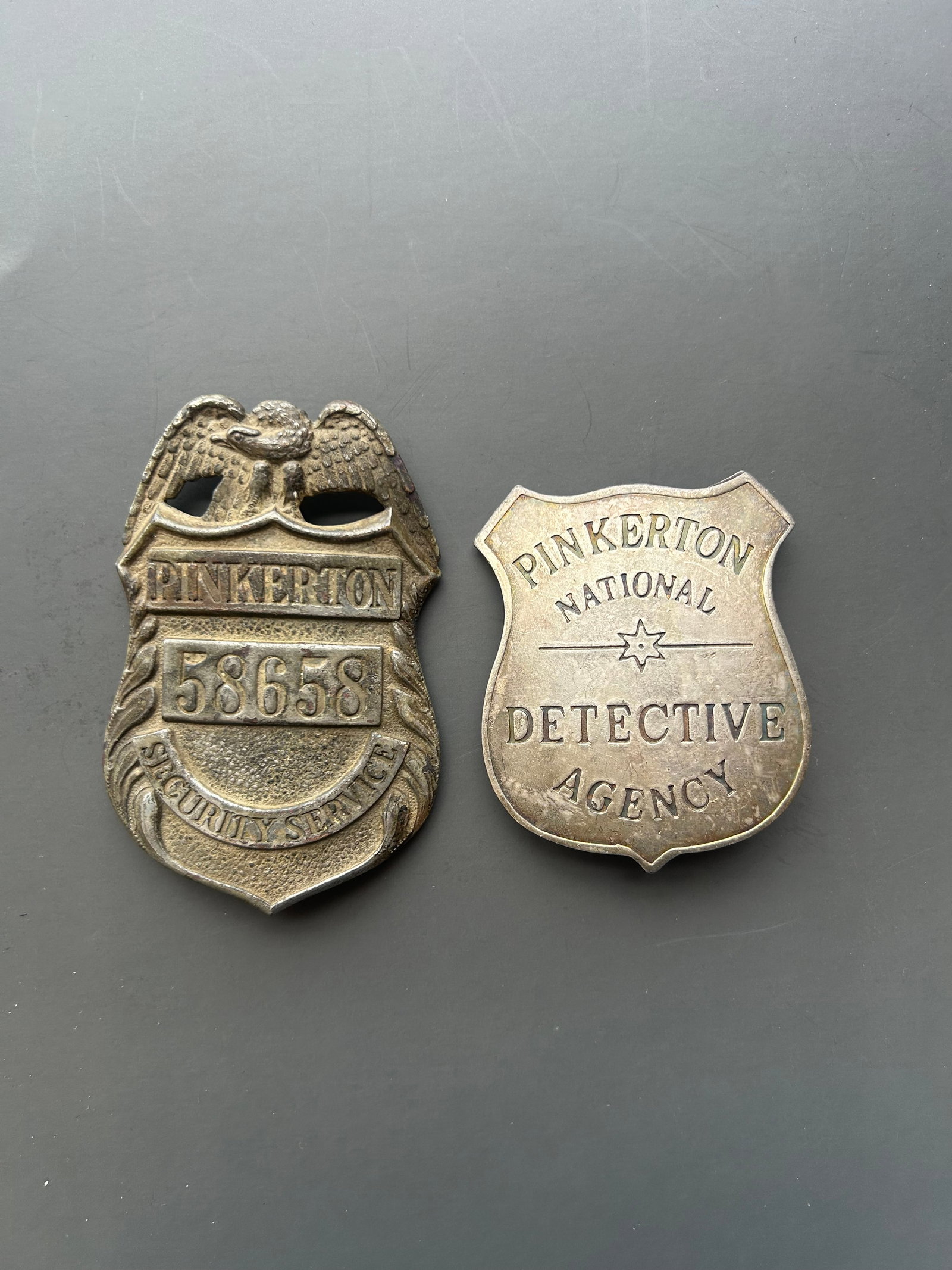 CIVAL WAR PINKERTON NATIONAL DETECTIVE & SECURITY: THESE METAL SHIELD BADGES SYMBOLIZE THE PINKERTON NATIONAL DETECTIVE AGENCY AND THE PINKERTON SECURITY SERVICE, POWERHOUSES IN EARLY AMERICAN PRIVATE LAW ENFORCEMENT AND CORPORATE SECURITY. LAUNCHED I