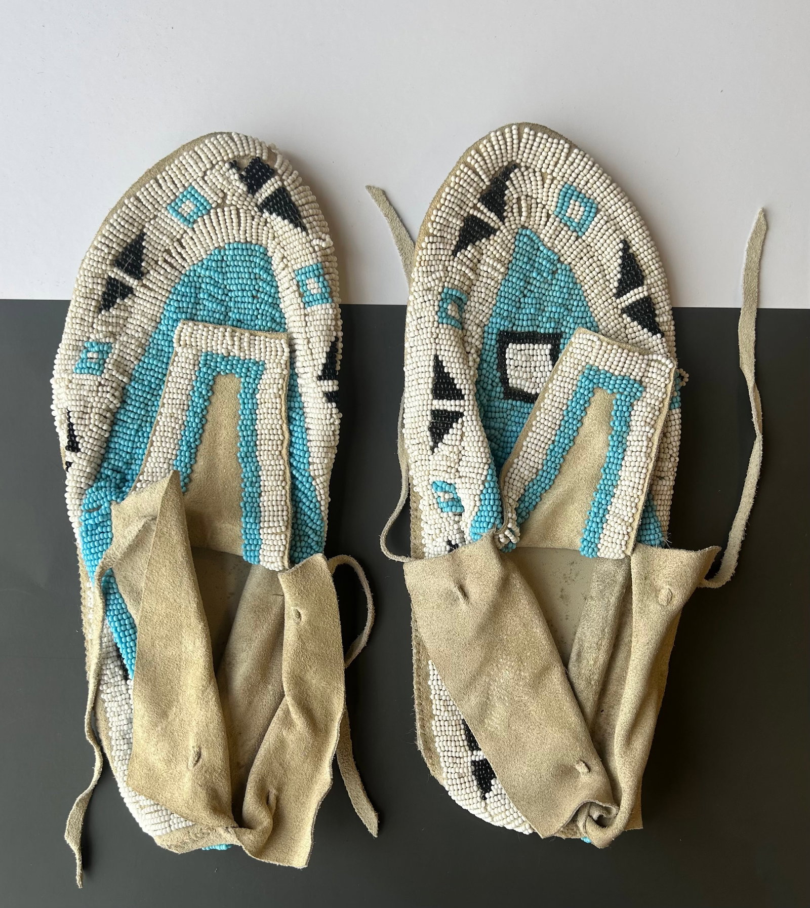 PAIR OF NORTHERN PLAINS BEADED MOCCASINS: 2 PAIR OF NORTHERN PLAINS STYLE HAND BEADED AND STITCHED MOCCASINS ON HIDE, BLUE AND WHITE BEADING, 12'', CIRCA FIRST QUARTER OF 20TH CENTURY, PROVENANCE: ESTATE OF DOUG DIVISH, NORTHEAST OHIO