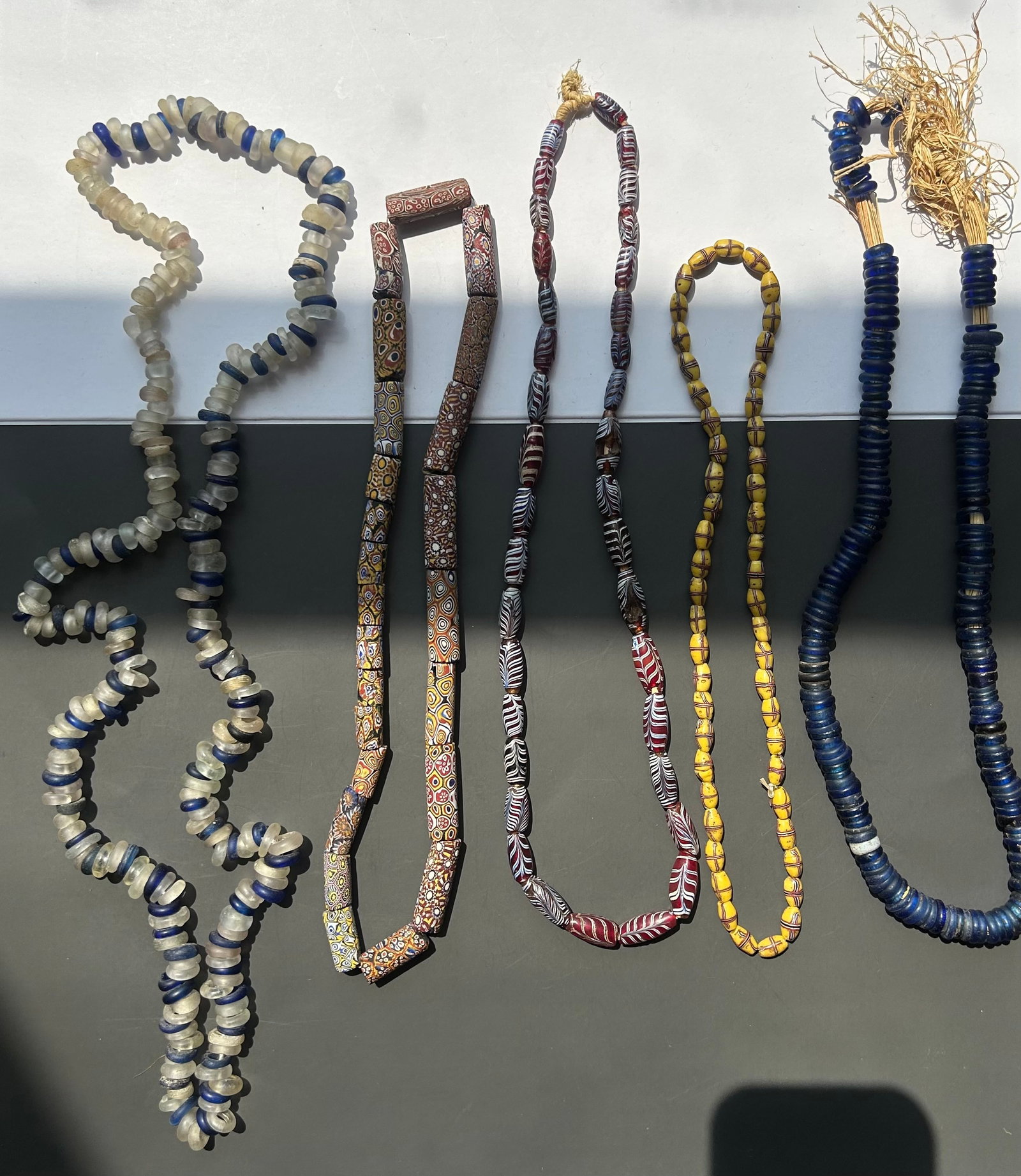 COLLECTION OF VENETIAN GLASS TRADE BEADS: LOT OF FIVE NECKLACES COMPOSED OF VENETIAN TRADE BEADS, INCLUDING A VARIETY OF CLASSIC AFRICAN TRADE BEAD STYLES. A VISUALLY APPEALING COLLECTION SUITABLE FOR DISPLAY, STUDY, JEWELRY DESIGN.