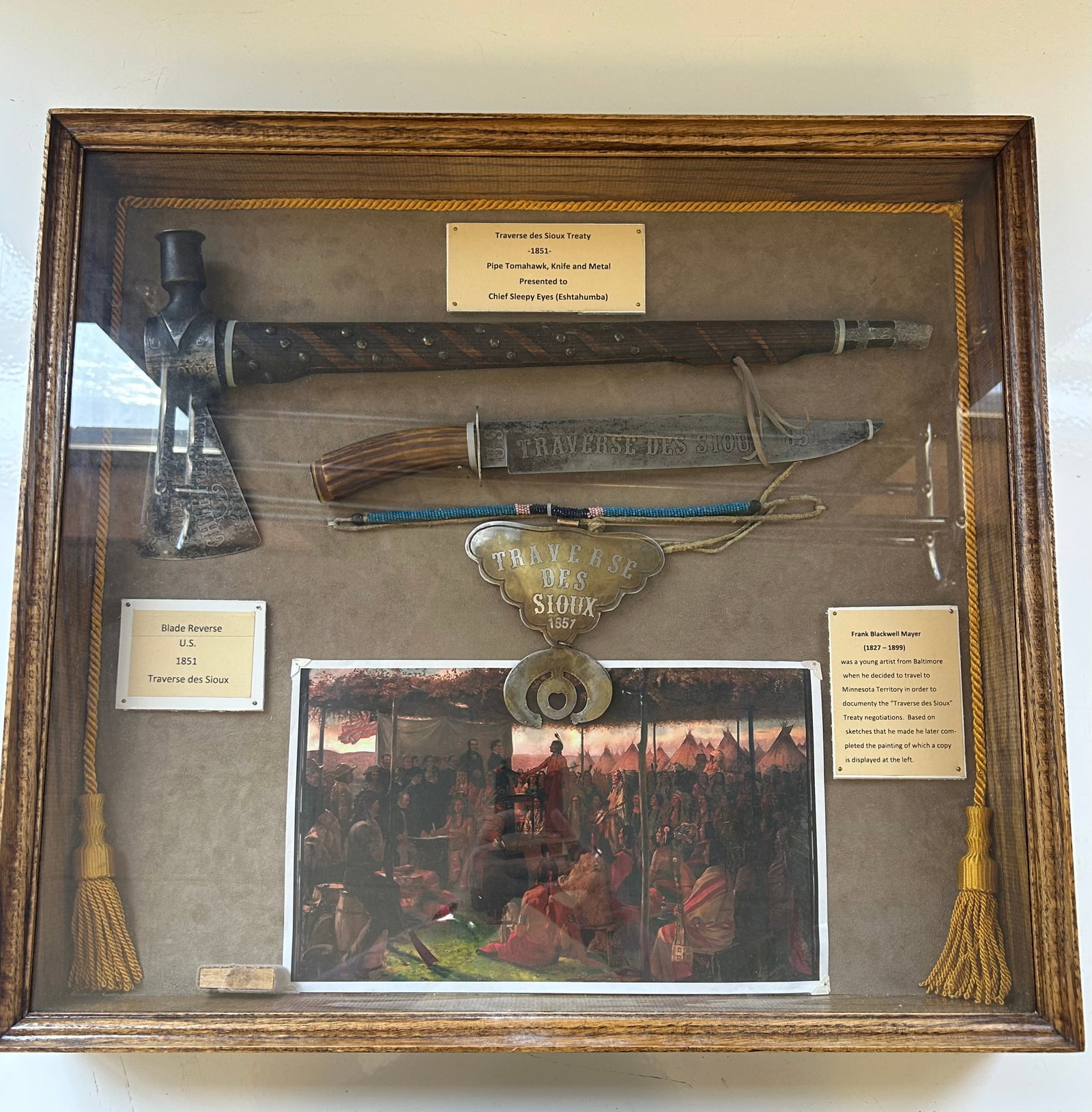 TRAVERSE DES SIOUX & CHIEF SLEEPY EYE DISPLAY: DISPLAY CASE (23"H X 25"W) DEDICATED TO CHIEF SLEEPY EYE AND HIS ROLE IN THE TRAVERSE DES SIOUX TREATY IN MINNESOTA, 1851. FEATURES A PIPE TOMAHAWK, ENGRAVED KNIFE, BRASS "TRAVERSE DES SIOUX 1851"