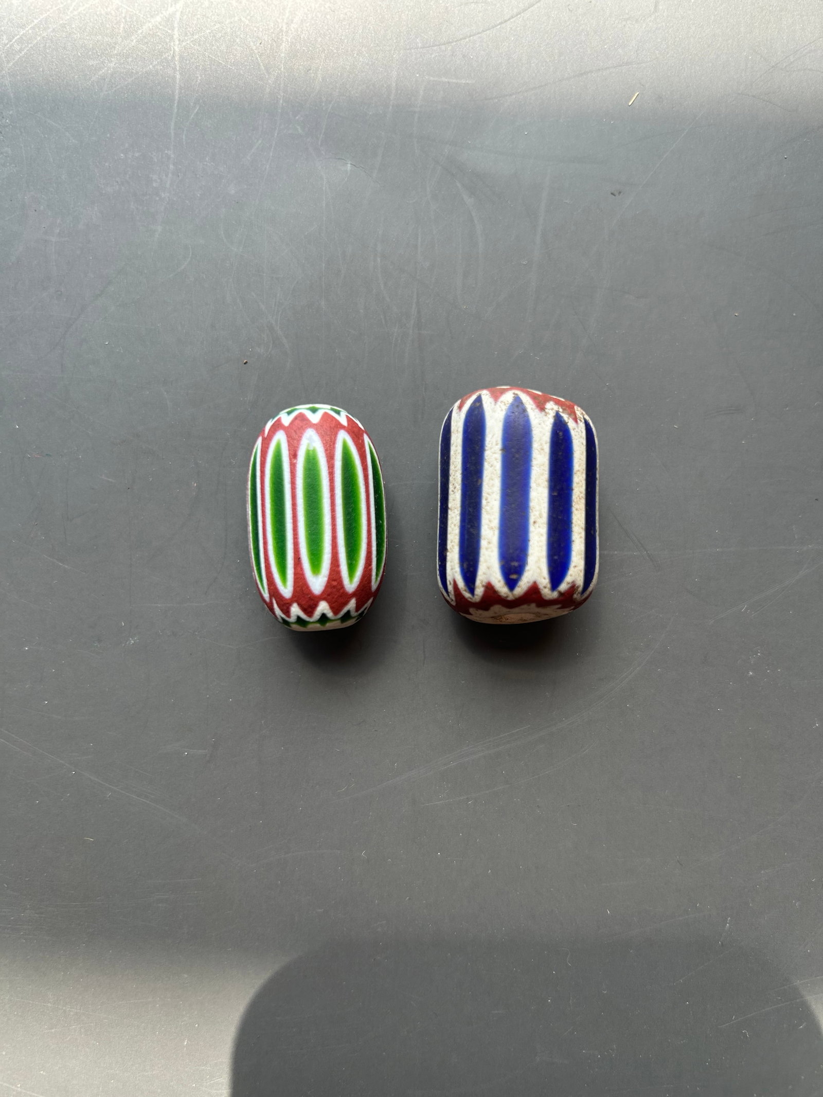 PAIR OF LARGE ANTIQUE VENETIAN TRADE BEAD: ATTRACTIVE PAIR OF ANTIQUE VENETIAN DRAWN GLASS TRADE BEADS FEATURING RELATED STRIPED POLYCHROME DECORATION. EACH MEASURE APPROX. 1" PROVENANCE: DOUG DIVISH, NORTHEAST OHIO