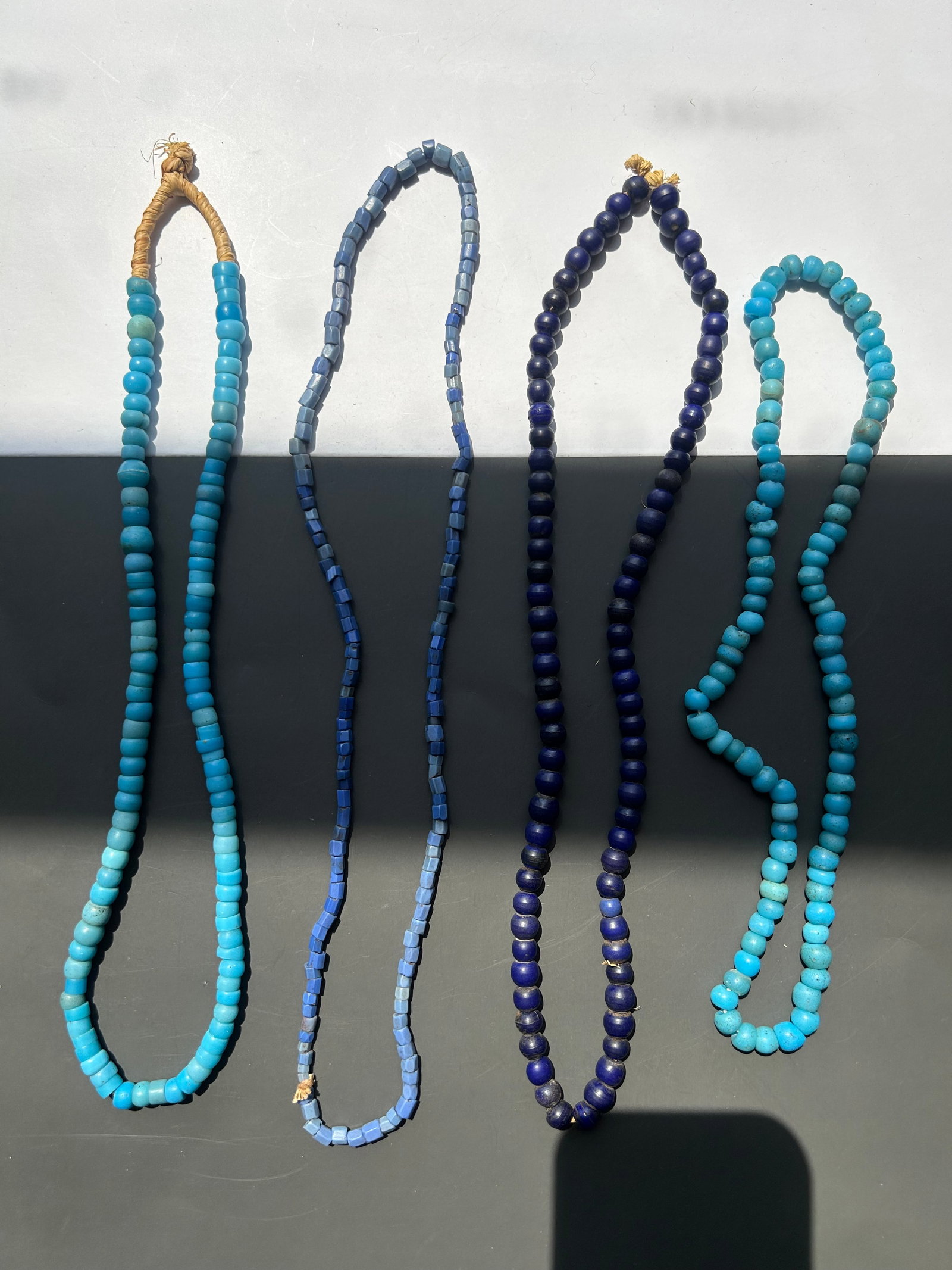 BEAUTIFUL COLLECTION OF ANTIQUE TRADE BEAD STRANDS: AN EYE CATCHING COLLECTION OF ANTIQUE BLUE TRADE BEAD STRANDS ASSEMBLED FROM AN OLD COLLECTION. THIS ATTRACTIVE GROUPING FEATURES A VARIETY OF SHADES, FORMS, AND MANUFACTURING STYLES, INCLUDING DEEP