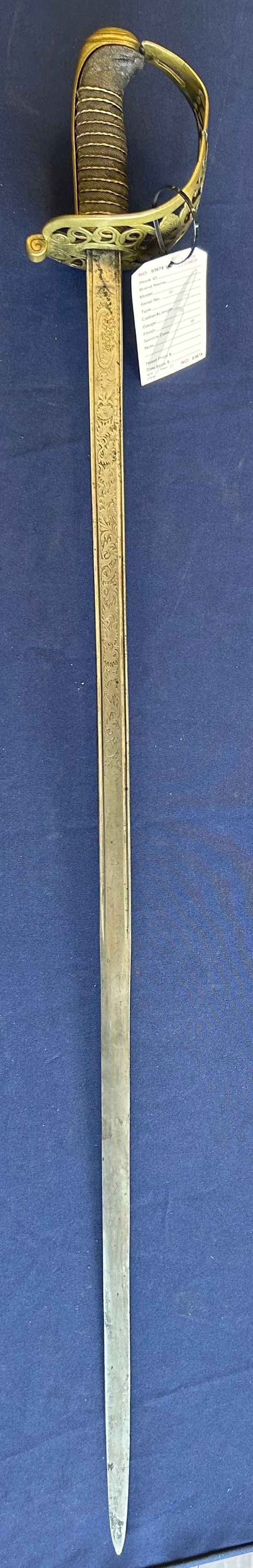 1844 SPANISH TOLEDO CAVALRY OFFICER'S SWORD: MID 19TH CENTURY SPANISH OFFICER'S SWORD FEATURING AN APPROXIMATELY 37 INCH BLADE WITH EXTENSIVE ETCHED FLORAL DECORATION. THE BLADE IS MARKED ON OPPOSITE SIDES "FABRICA NACIONAL DE TOLEDO" AND "ANO D