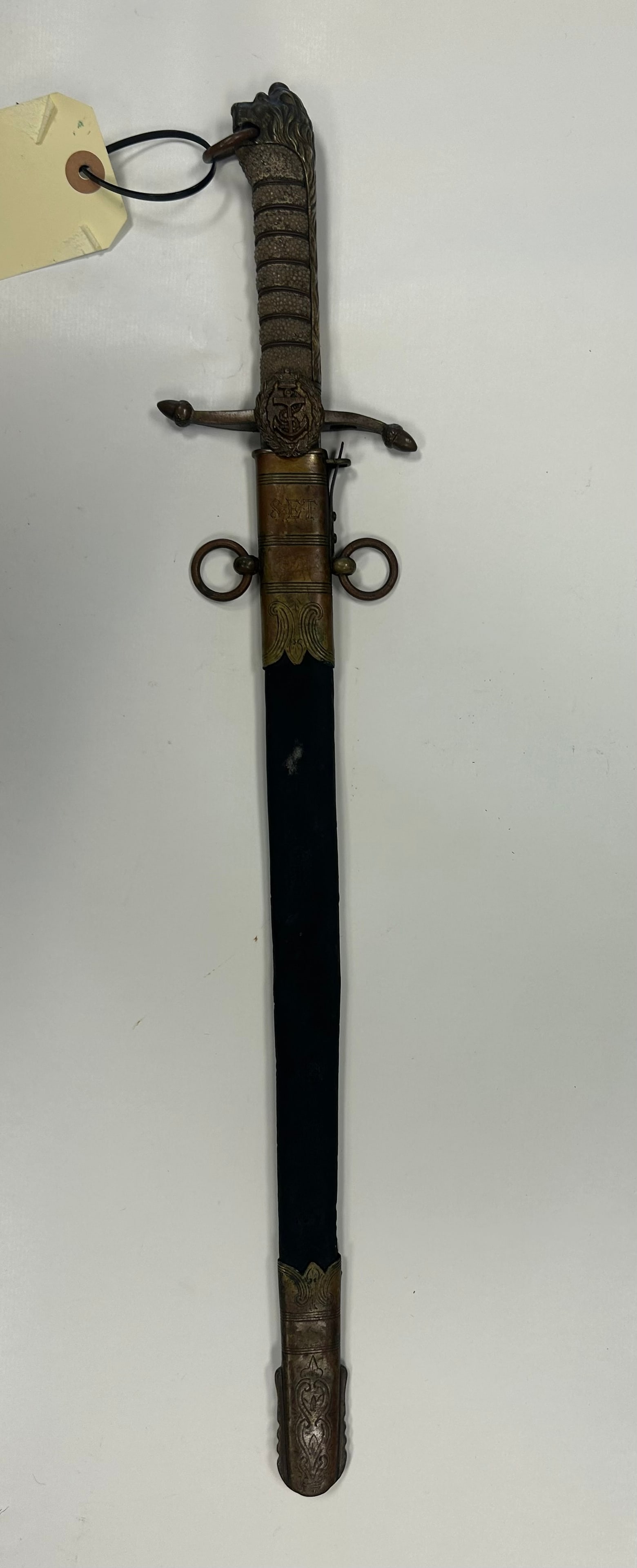 BRITISH ROYAL NAVY MIDSHIPMAN'S DIRK: EARLY 20th CENTURY ROYAL NAVY MIDSHIPMAN'S DIRK BY J. GIEVE & SONS, PORTSMOUTH, FEATURING AN ETCHED BLADE, ORNATE BRASS HILT AND MOUNTED SCABBARD ENGRAVED "S.E.T." BLADE LENGTH IS APPROX. 18". A HANDS