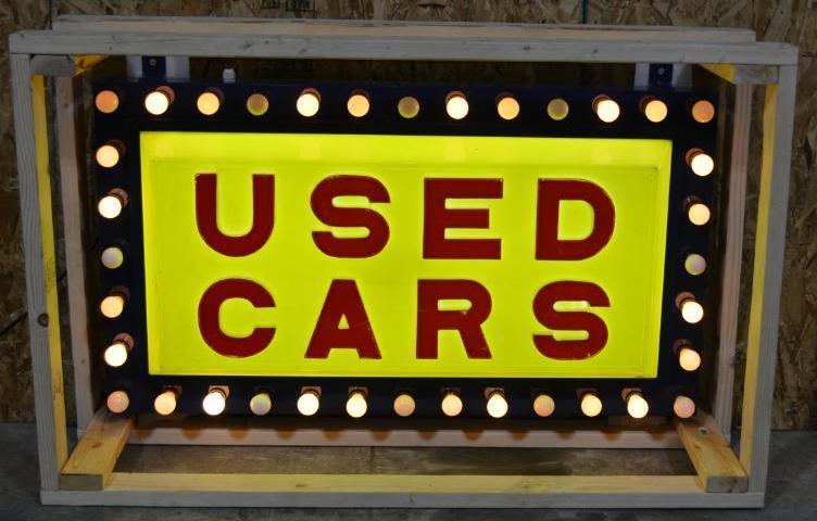 Used Cars Lighted Flashing Plastic Sign: Single-sided molded plastic sign mounted in a new metal frame, has light bulbs that chase around the perimeter, 30"x54"x9", rated 9 TAC #008077