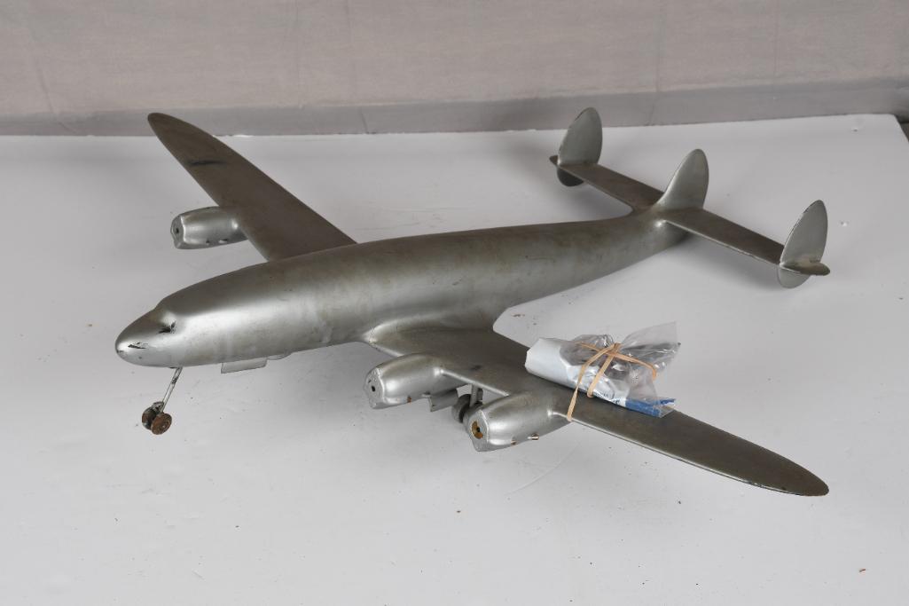 Constellation Style Wood Body Airliner: rated 8, 30.5" wingspan, has a wood body with thick covering, has minor wear and dings, comes with four metal propellors.Ã‚