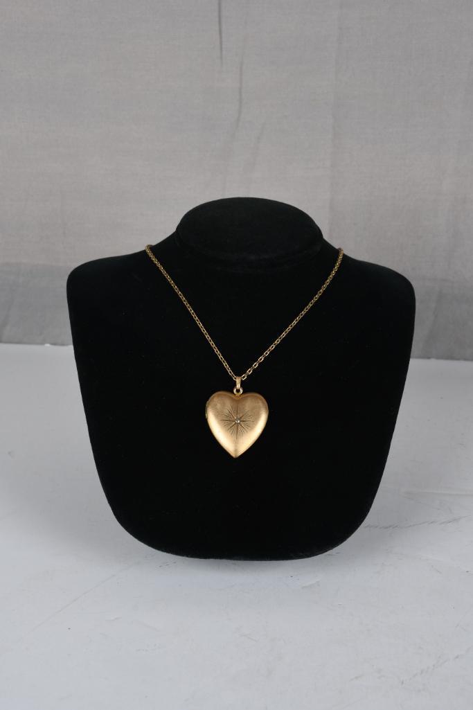 Gold Filled Heart Locket on GF 18" Chain: Gold filled heart locket with stone in the middle of the heart. Locket is on a 18" GF chain. Marked gold filled on the inside. In good condition.