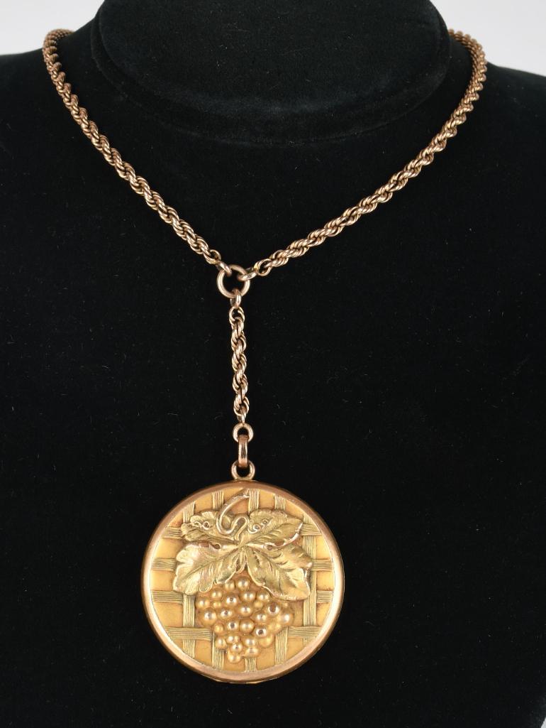 Gold Filled Grapes Locket on GF 18" Chain: Gold filled round locket with grapes on the front. Locket is on a 18" GF chain. It has initials engraved on the back. In good condition.