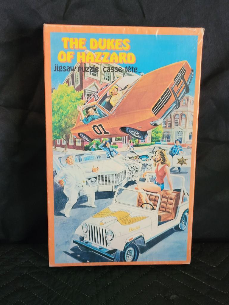 The Dukes of Hazzard Jigsaw Puzzle: Nice display piece.Ã‚ Unsure if all puzzle pieces are in box. Cassette is missing and there is some age wear present on box with tape at ends.