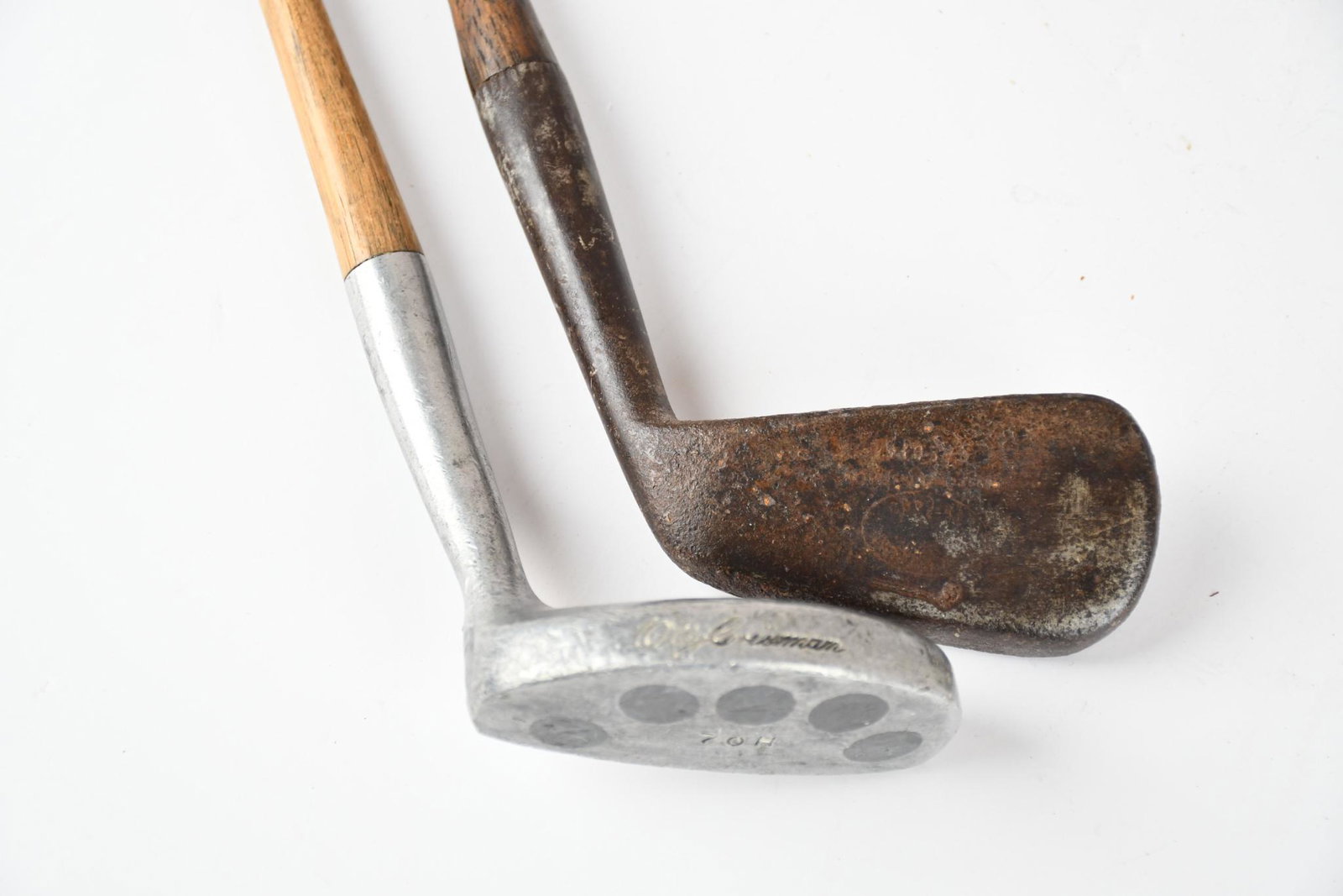 2-Unmarked Golf Club: rated 7, 39"L or less in size, both have metal putters with wear and dings, hickory shaft and leather handles.