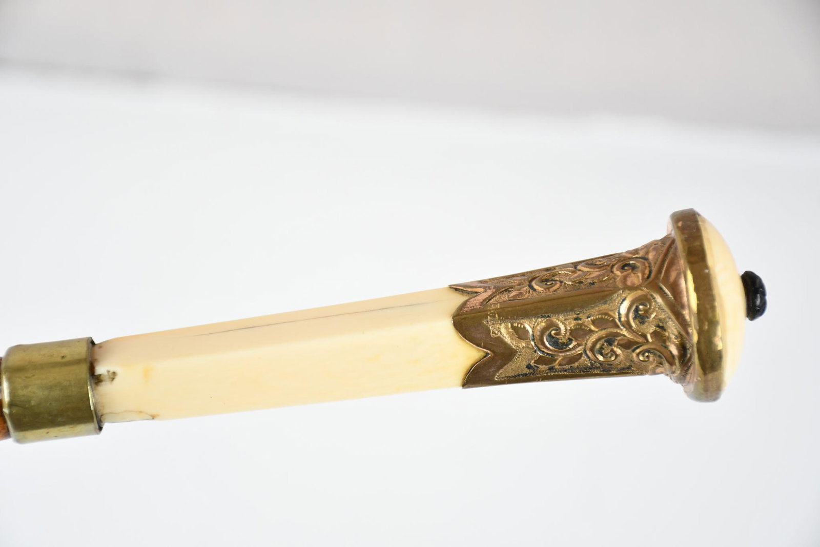 Bamboo Walking Stick: rated 8, 36"H., the walking stick has a bamboo shaft, top is bone and gold filled metal, bone has a few fine cracks, does has sword insided.
