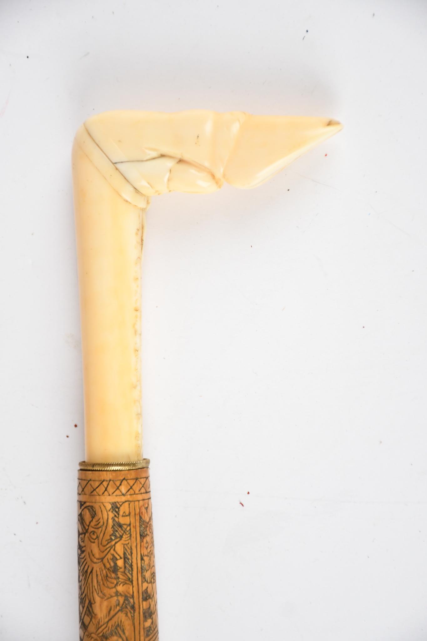 Hoof Top Sword/Cane: rated 7.5, 35"H., carved bamboo shaft has light wear, the carved bone top into a hoof, metal blade is in good condition with no markings.