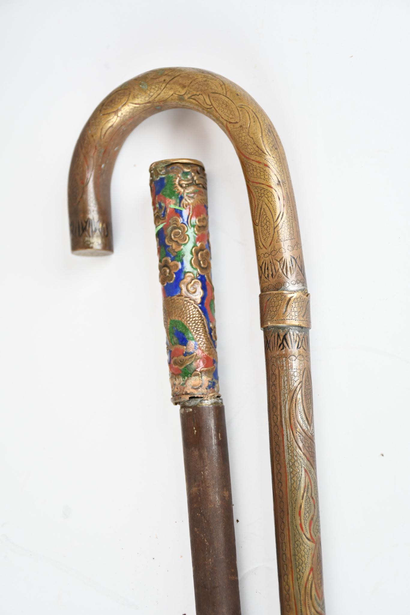 2-Metal Sword/Canes: rated 6 & 7, 36"H. or less in size, curve hand one has etched decorates blade is in good condition, other has good blade has damage to shaft and handle.