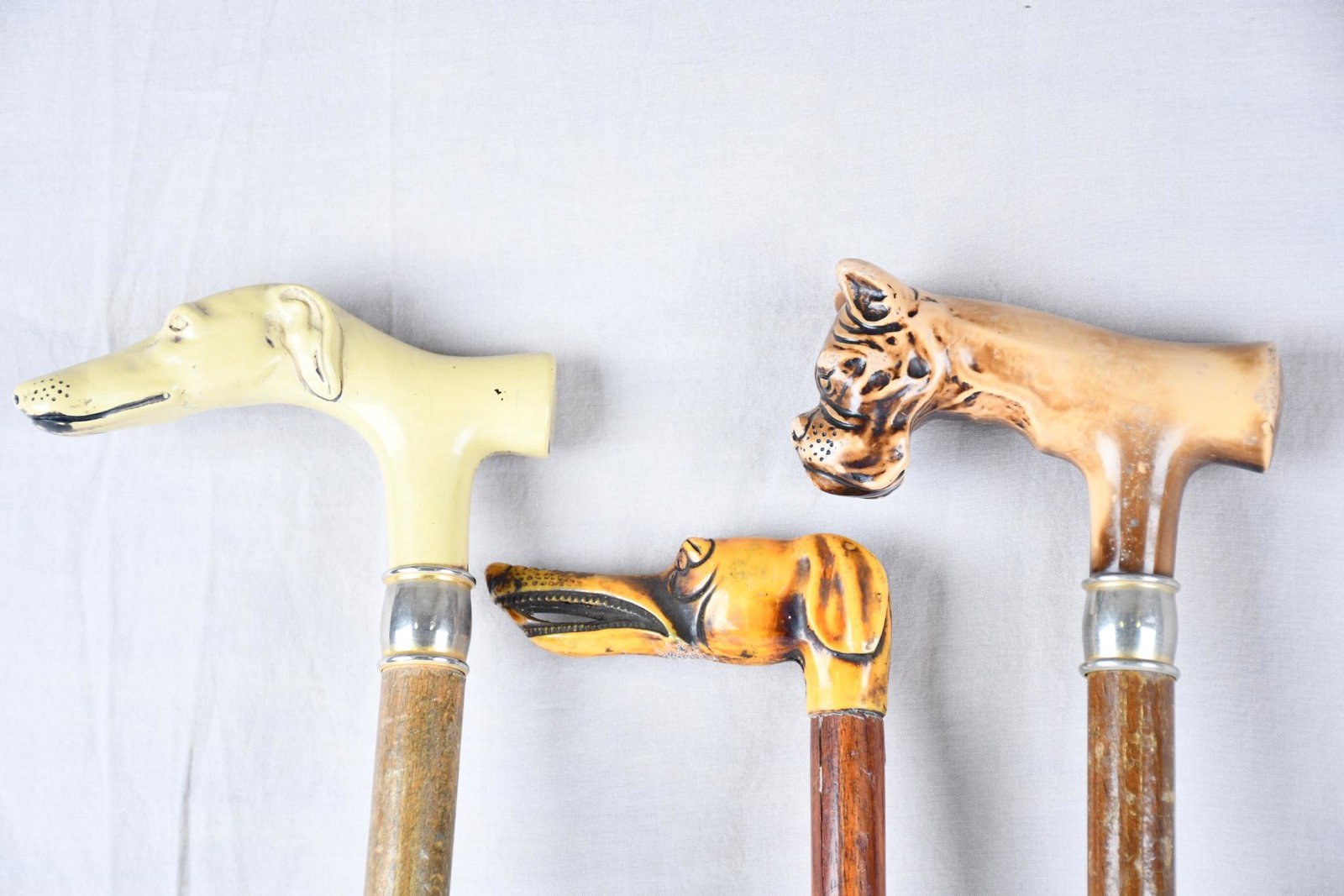 3-Dog Head Canes: rated 8, 36"H. or less in size, all have wood shafts, tops are all different materials.