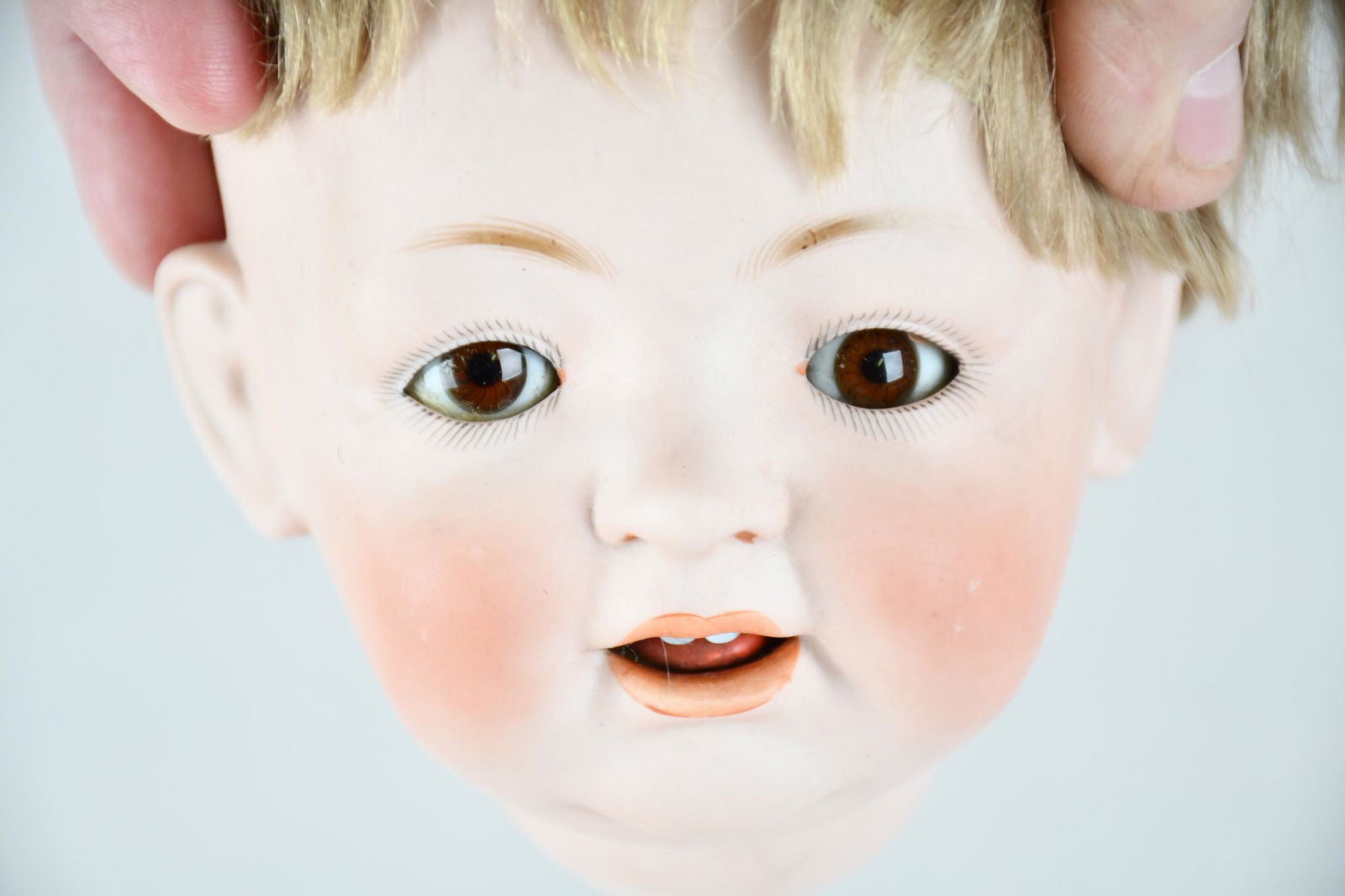 J.D.K Bisque Head & Body Made in Germany: rated 9, 18"H., the full bisque head and body doll is in very good condition, has sleeping eyes, open mouth with two teeth, jointed body, back of the head is marked J.D.K. 226 Made in Germany, has