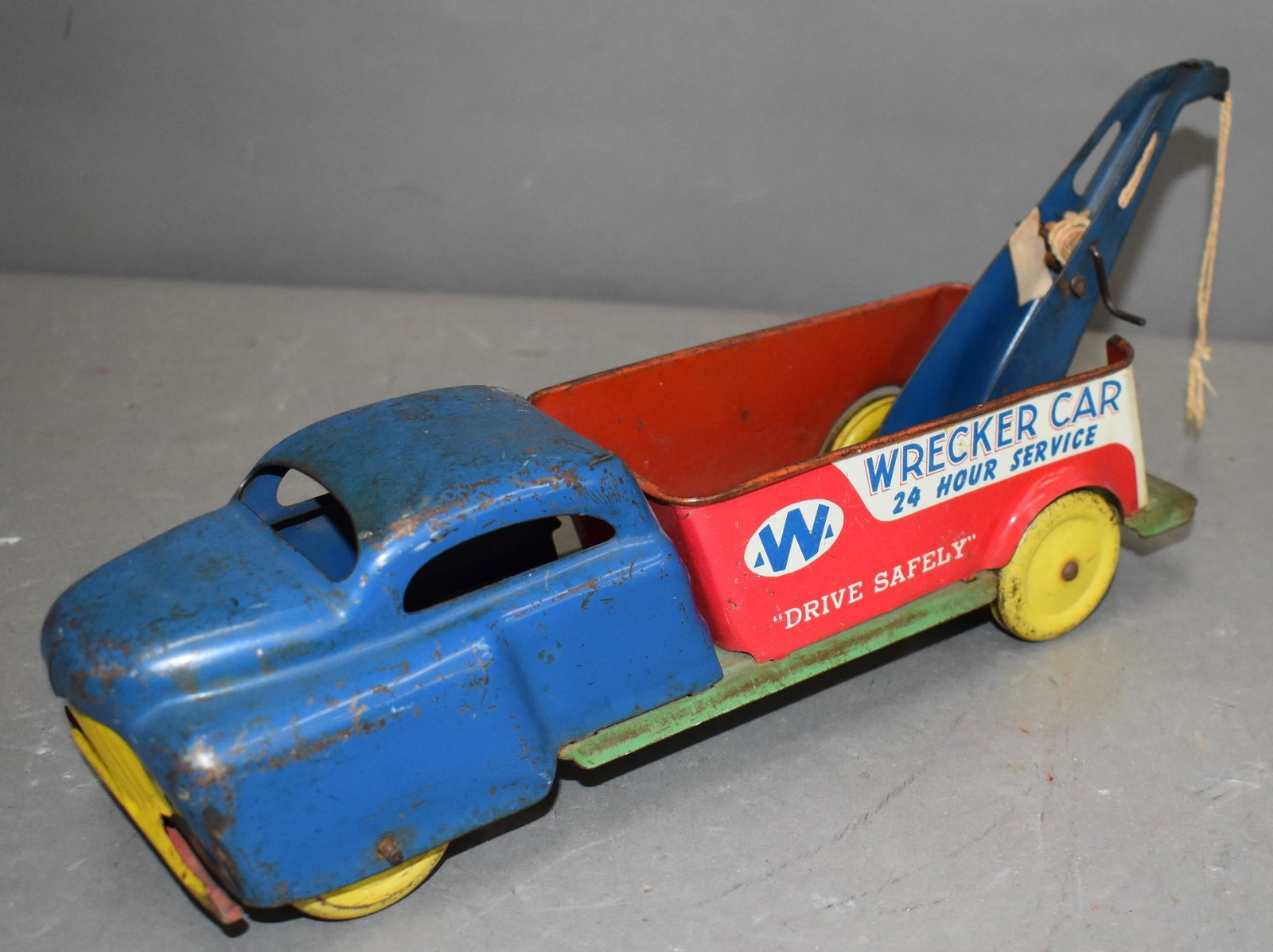 Wyandotte Tin Litho "Wrecker Car" Truck: rated 7, 13"L, tin litho truck has wear, scratches and paint chips, metal wheels.