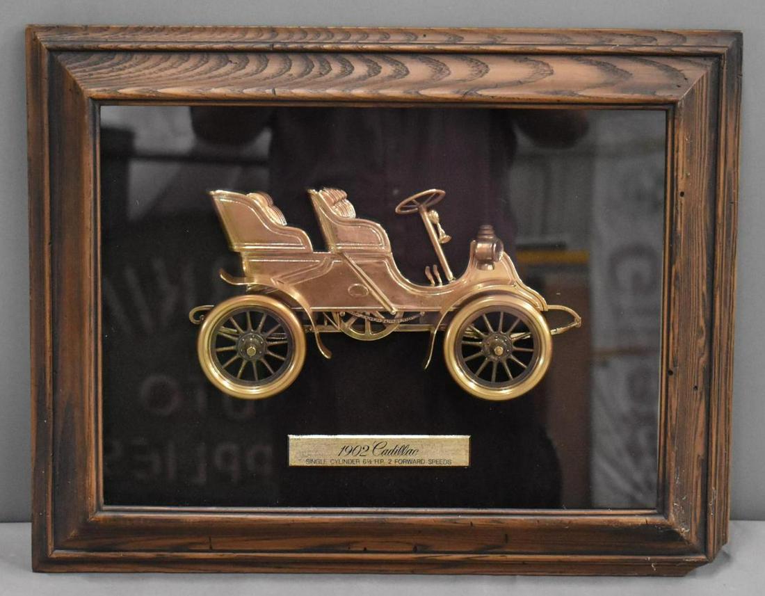 1970's Cadillac Showroom Shadow Box w/1902 Car: rated 8.5, 18.5"x23.5", shadow box frame has a chipped corner otherwise in good condition.