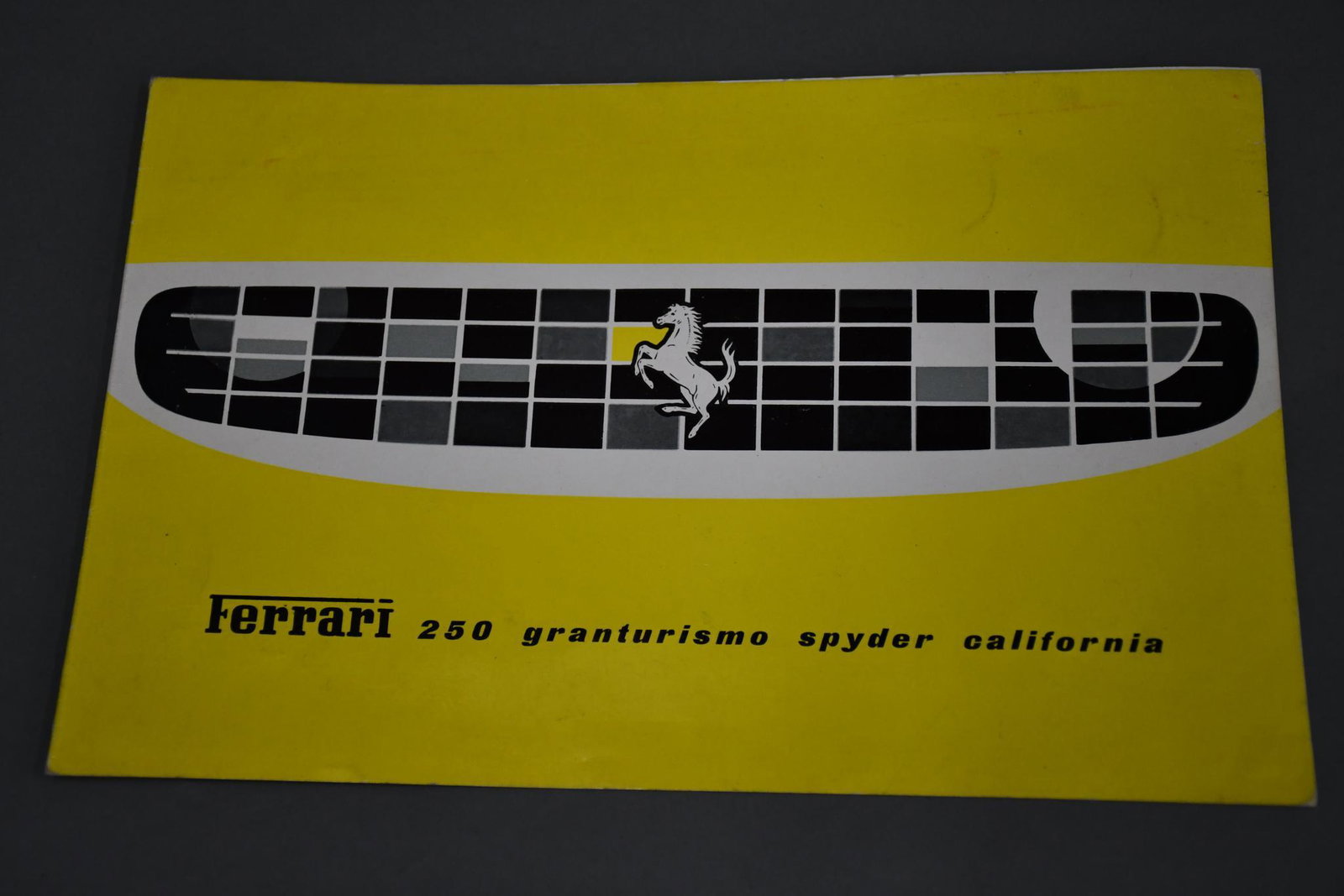 Ferrari 250 Granturismo Spyder California Sales Literature: rated 8.9, 7"x11", color cover has light wear, inside has black and white images of Car, engine and specs.