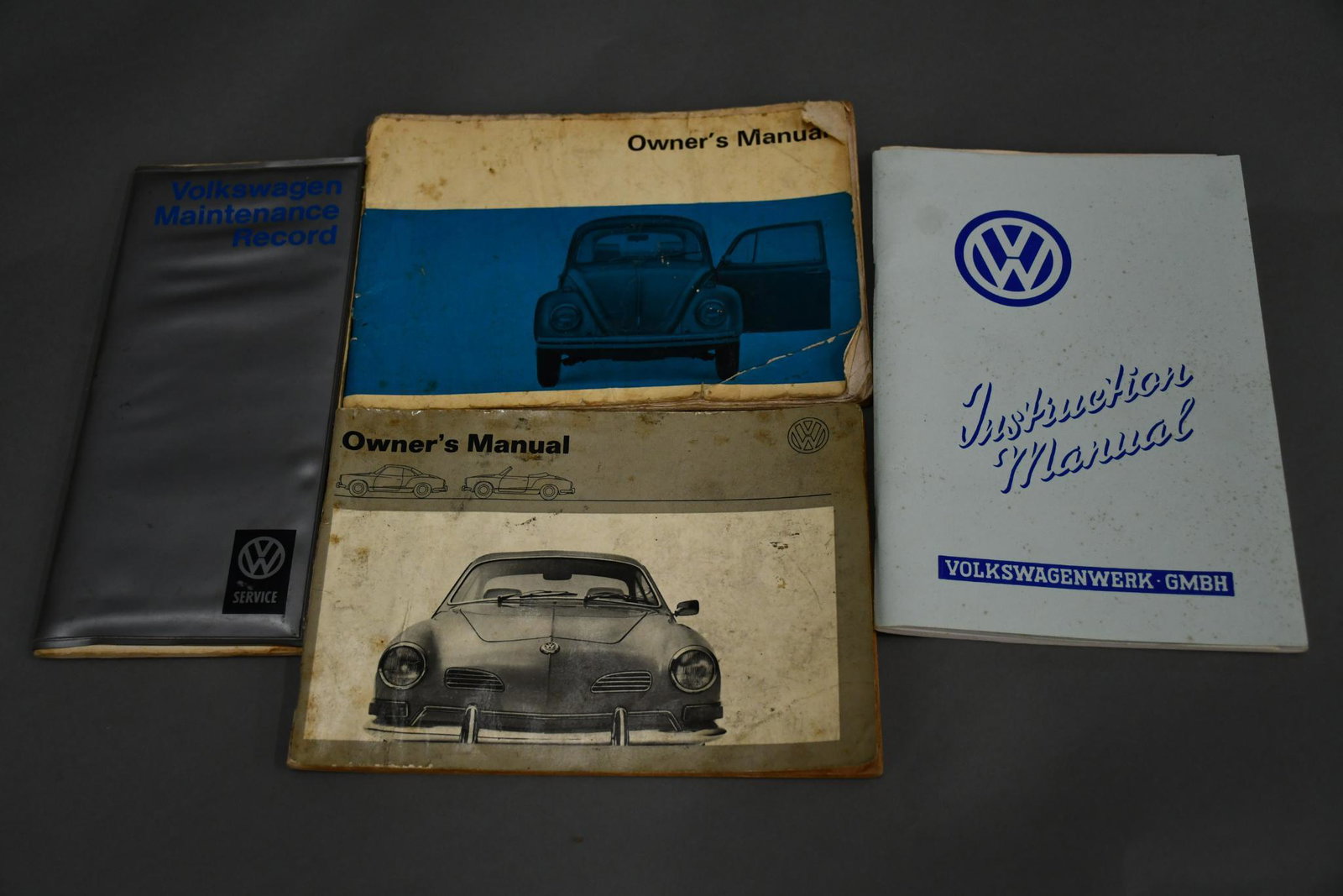 Volkswagen Owner's Manuals: rated 6.5 to 8, 8.5"x6" or less in size, bug has wear and creases, Karma Gia is soiled