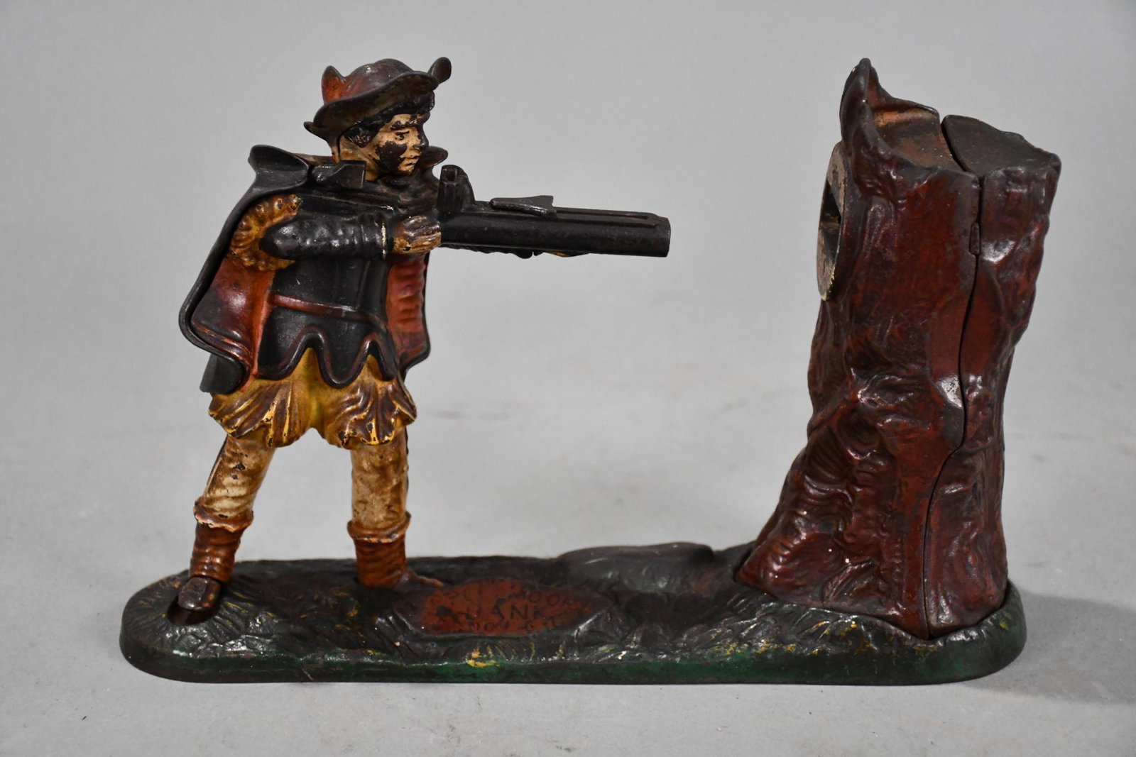 Creedmore William Tell Cast Iron Motion Bank: rated 7, 6.75"T., the cast iron bank is original paint with wear and soiling, works well, trap is missing.