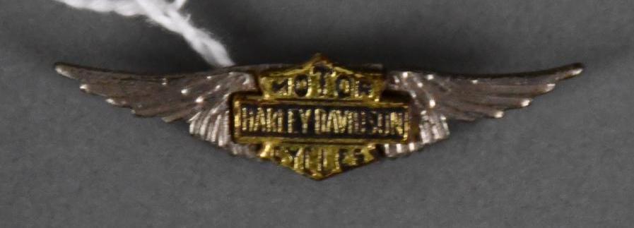1950's Harley-Davidson w/Wings Metal Pin Back: rated 9, .5"x1.75", metal pin back is in good condition, marked Made in USA on back.