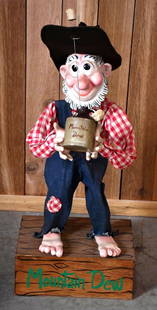 Mountain Dew Hillybilly Statue: rated 8, 44"T., the statue is made of plastic mounted on a wood base, the hat is not original.