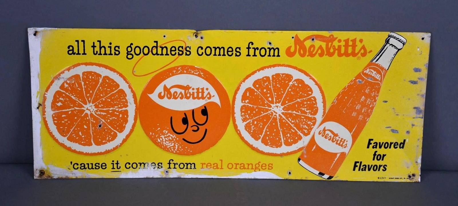 Nesbitt's "all this goodness comes from" w/Logos Metal Sign(TAC): rated 7.25, 12"x30", SST embossed sign has good color and shine, has wear, has extra holes, paint and wear around the perimeter, marked Stout. TAC #043842