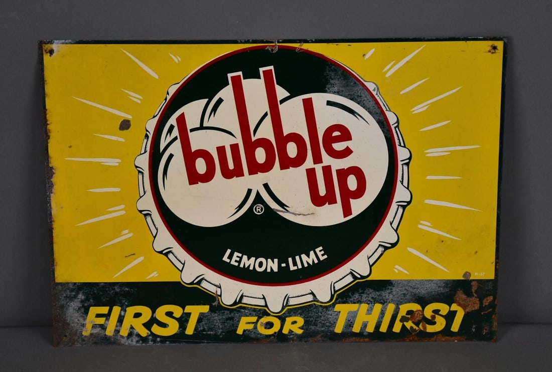 Bubble Up Lemon-Lime "First for Thirst" w/Bottle Cap Logo Metal Sign (TAC): rated 6.75, 14"x20", SST sign has wear, scratches and staining. TAC #043812