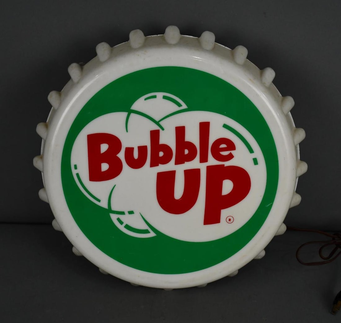 Bubble Up Plastic Bottle Cap Lighted Sign: rated 8.25, 16"x16"x4", the plastic bottle cap has good color, has light wear, metal can is in good condition, has original Tel-a-sign decal on back, works.