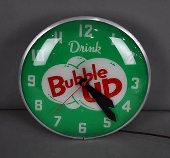 Drink Bubble Up Lighted Clock: rated 9, 15"D., the lens is in excellent condition, metal can has light wear and has it's back door, lens is marked Swihart, lights up but clock does not work.