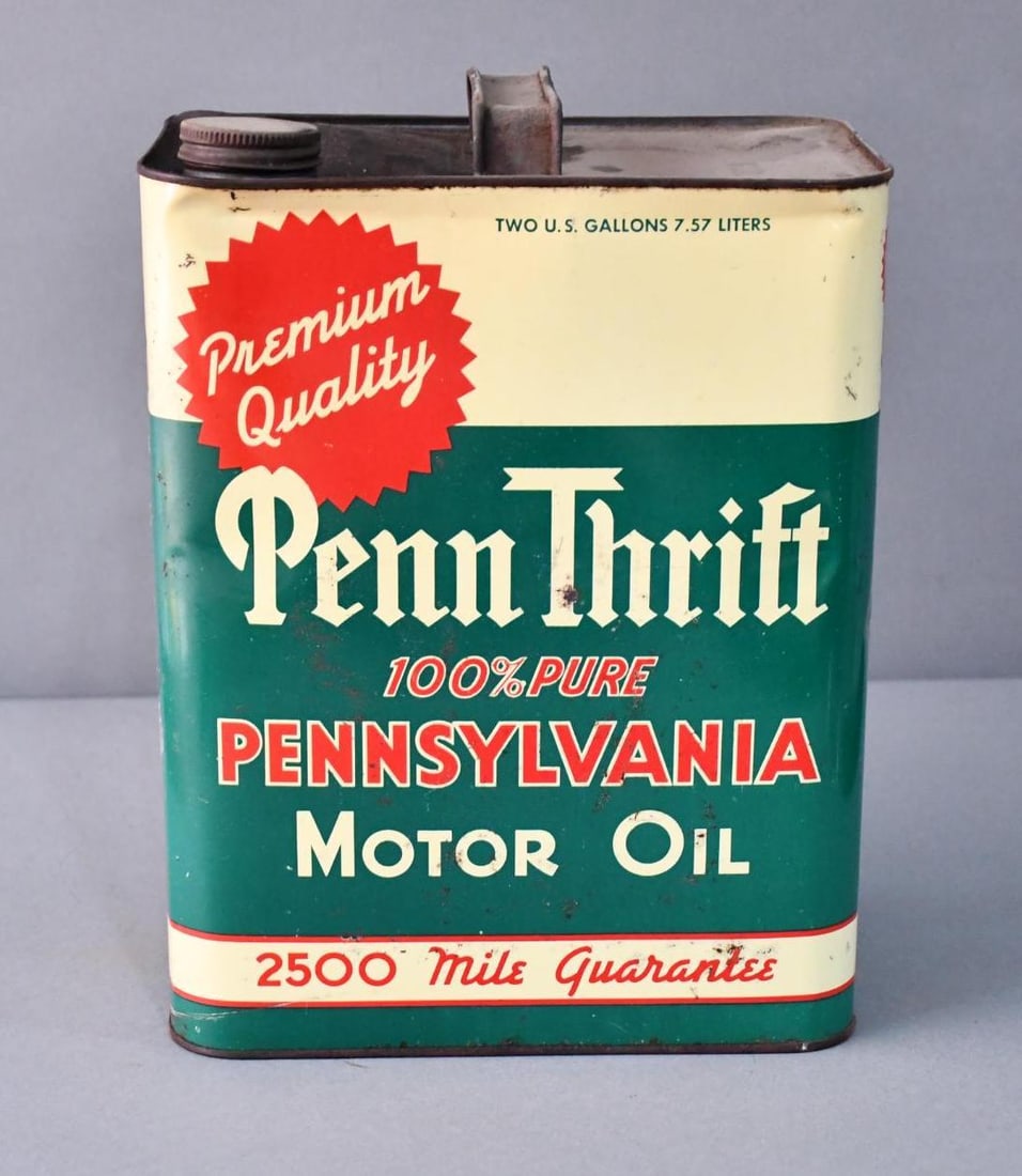 Penn Thrift 100% Pennsylvania Motor Oil Two-Gallon Metal Can: rated 7.75 & 7, the two-gallon rectangle metal can has light wear, a few fine scratches and dent at the top edge, reverse has more wear, rust along on side, is empty.
