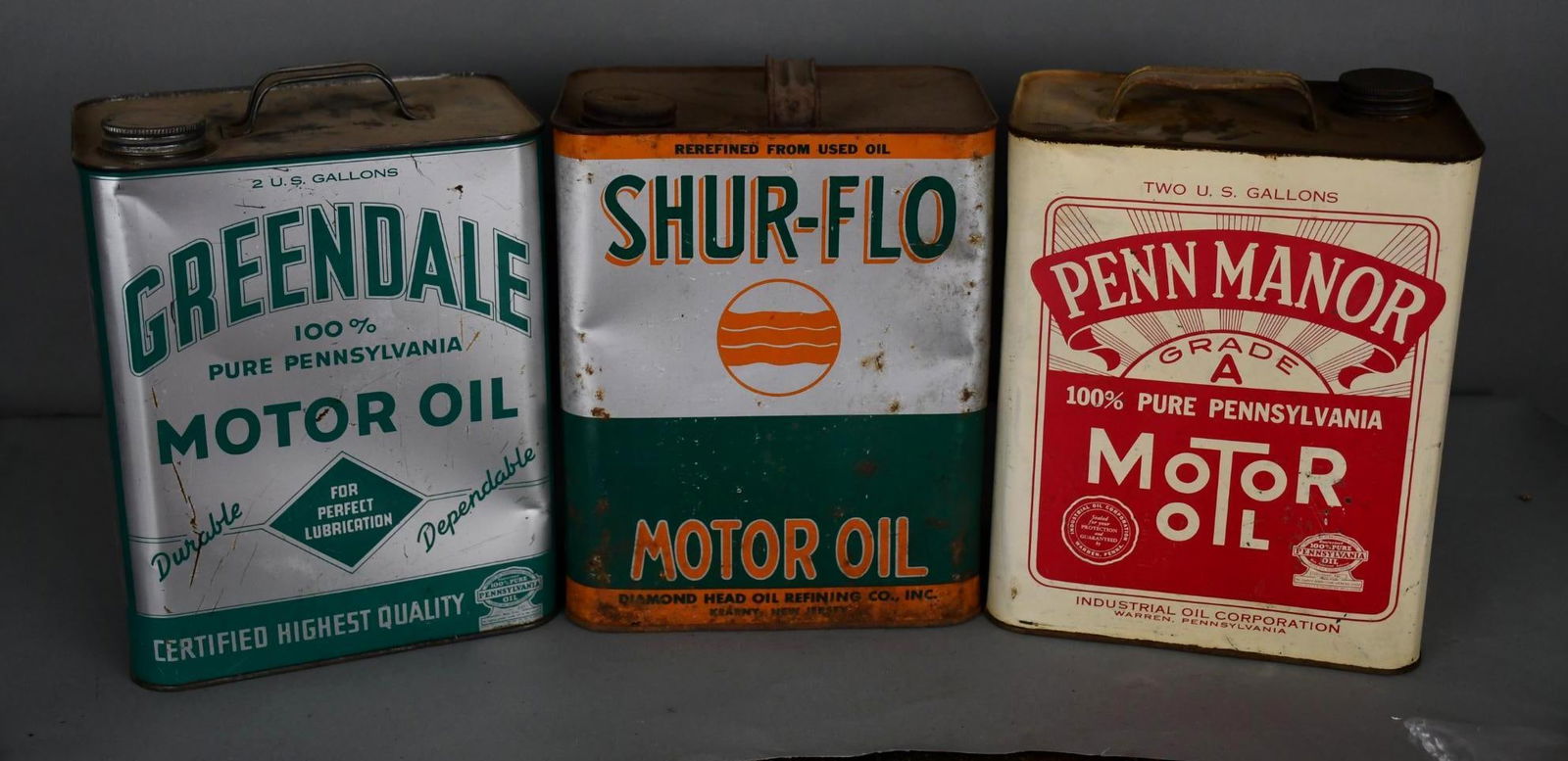 3-Two-Gallon Metal Motor Oil Cans Shur-Flo, Greendale & Penn Manor: rated 7 to 7.5, the two-gallon rectangle metal cans all have some wear, fine scratches and dings, all are empty.