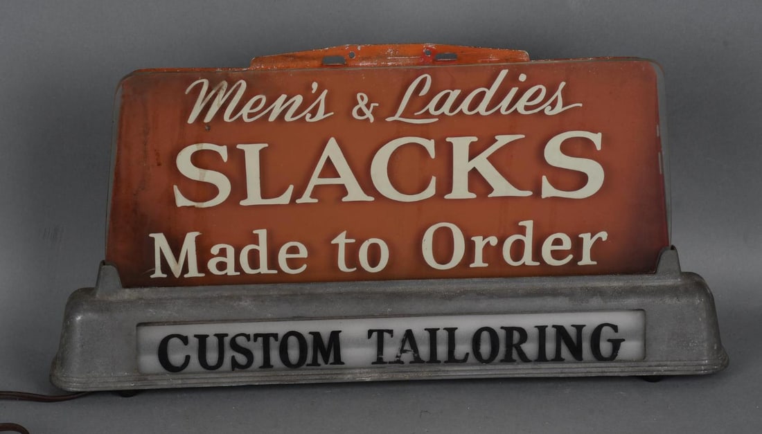 Men's & Ladies Slacks Made to Order Lighted Sign: rated 6.75, 10"x19"x3", the glass face is in good condition, metal back has wear, metal base has wear, light works.