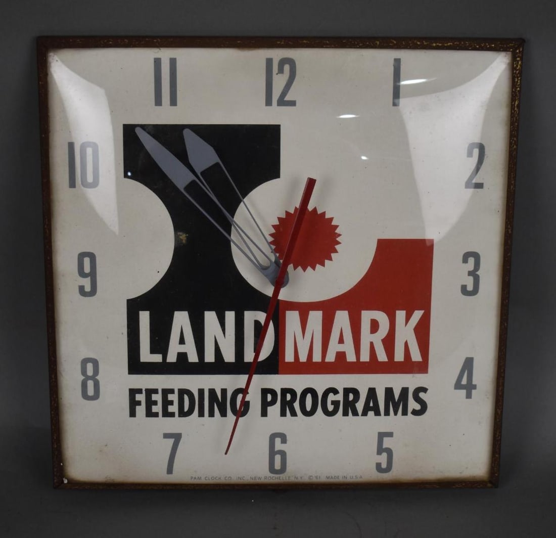 Landmark Feeding Program Clock: rated 8.25, 15"x15"x3", the clock face has light soiling, has glass bezel, meral frame and can, has light rust, clock works.