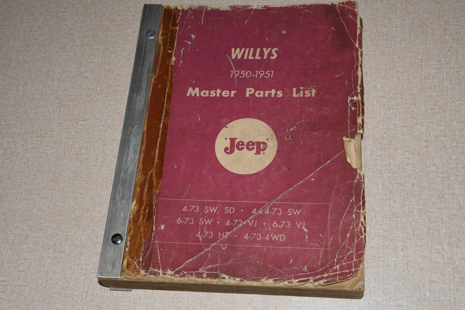 1950-51 Willys Jeep Master Parts Book 4-73 SW SD 6-73 SW 4-73 VJ 6-73 VJ 4-73: 11"x8.5", the bound catalog cover has wear and damage, inside has light wear.